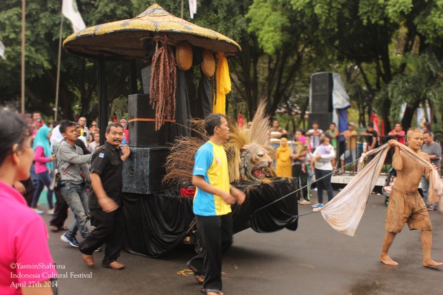 Harvest Ceremonial-Tradition from West Java. Look at the large farmer's hat and the chocolate rice that hanged on it.